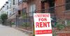 rent sign in front of building