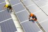 workers installing solar panels