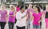 Group of women and men in pink, at breast cancer rally