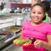 smiling child with tray of food