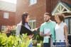 young couple talking with real estate agent