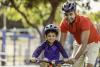 Child learning to ride bicycle