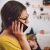 woman on cell phone with her child in the room