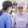 happy senior woman talking with doctor