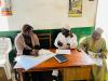 Two Nigerian officials sitting and talking