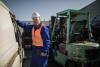 Male worker in an automotive junkyard