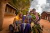 women in africa gathered around a portable radio